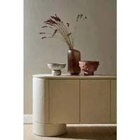 GlobeWest Pluto Buffet in Snowgum with rounded silhouette, four-door ash veneer storage unit with circular legs, modern minimalist design