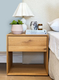 Stylishly arranged bedside table with decor items for bedside table styling service