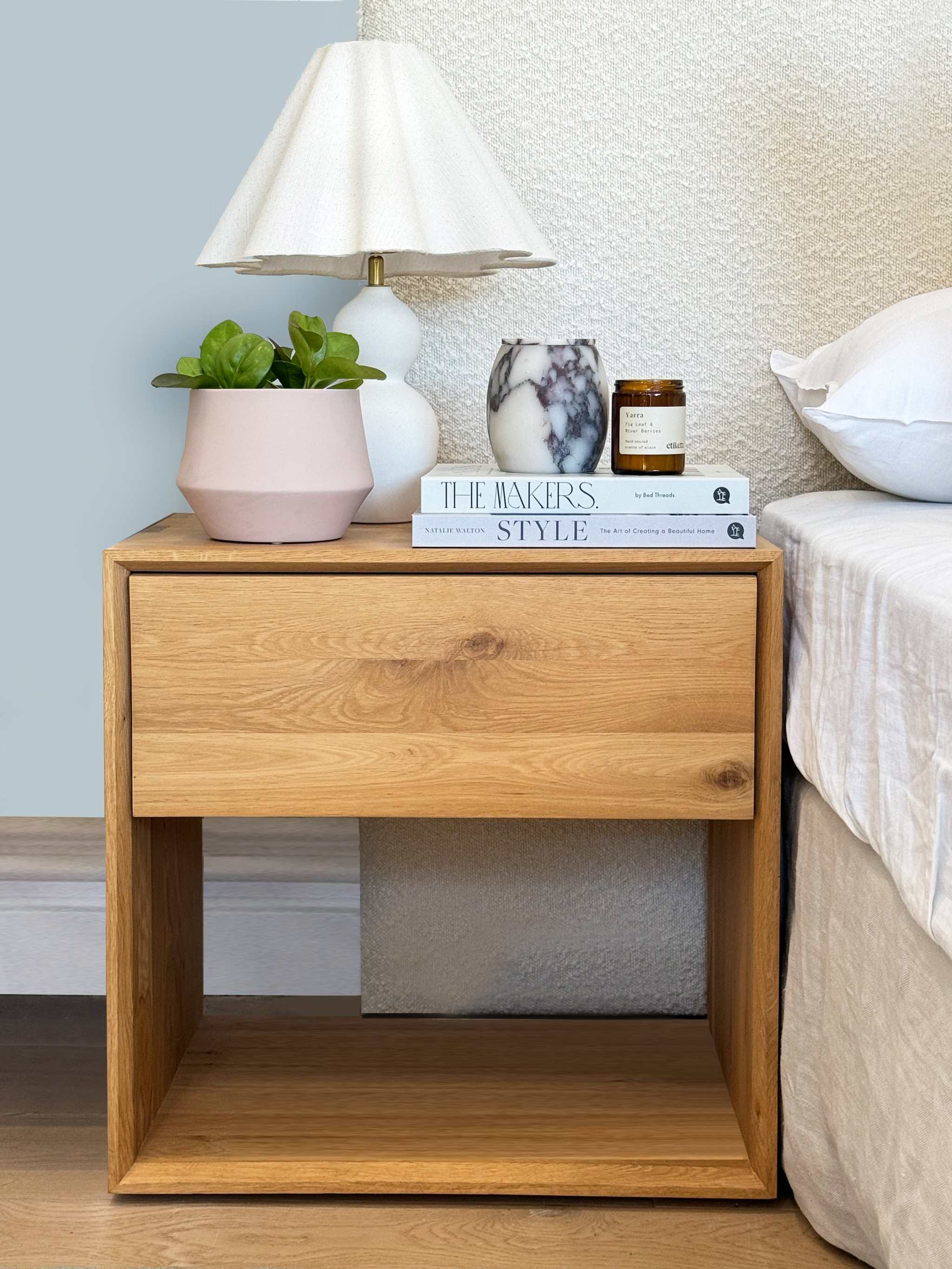 Stylishly arranged bedside table with decor items for bedside table styling service