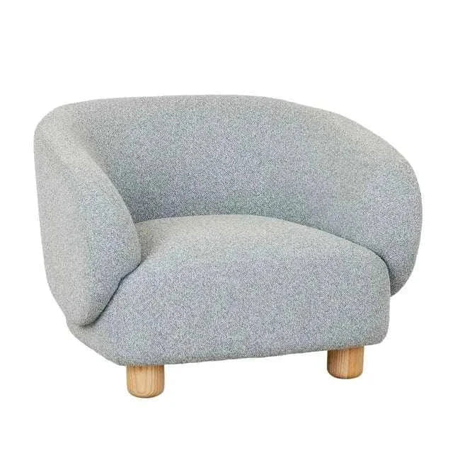 GlobeWest Flo Occasional Chair in Nimbus fabric with natural ash wooden legs, featuring a wraparound back and oversized pillar legs for modern comfort and style