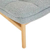 Close-up of GlobeWest Kip Occasional Chair leg in natural ash wood with nimbus grey polyester upholstery seat cushion