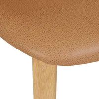Close-up of GlobeWest Sketch Pinta Dining Chair seat in pecan leather and light oak wooden leg