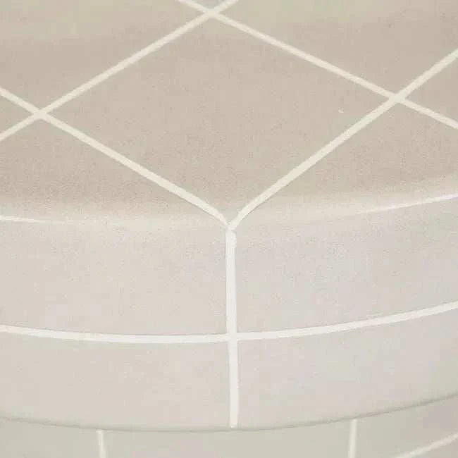 Close-up of GlobeWest Seville Tile round coffee table in pearl white with crisp grout lines and glazed finish