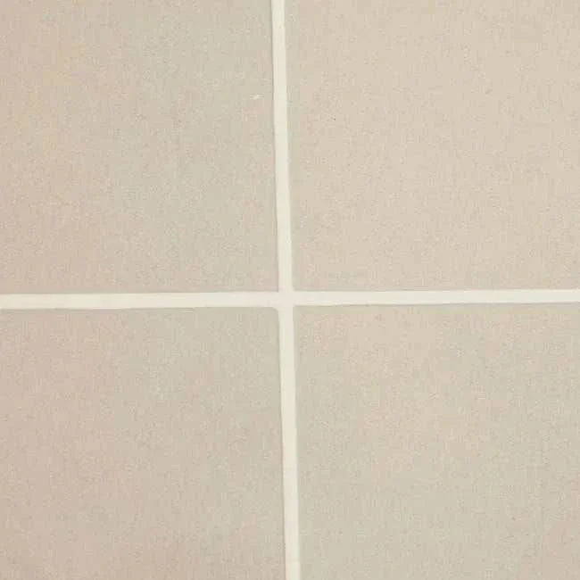 Close-up of pearl white tiled surface with crisp grout lines on GlobeWest Seville Tile round coffee table