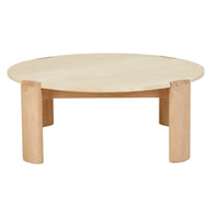 Willa Marble Coffee Table with natural travertine top and light oak ellipse-shaped legs in modern living room setting