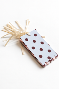 Scalloped gift tag threaded with ivory satin ribbon