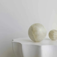 Large white onyx CoTheory Orbit Table Sculpture sphere symbolizing harmony and balance
