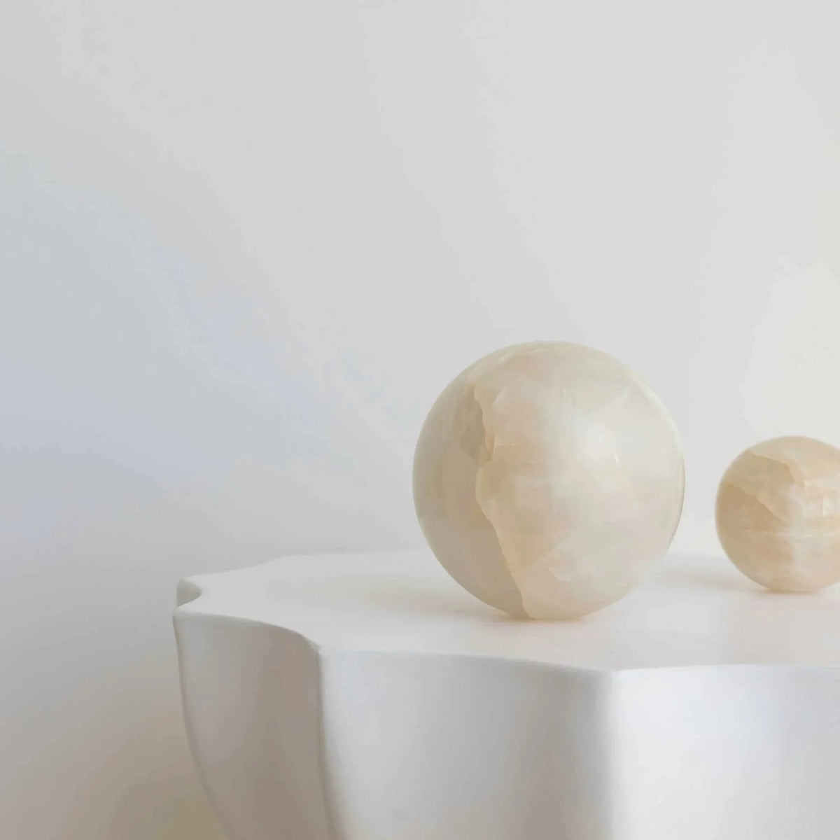 Large white onyx CoTheory Orbit Table Sculpture sphere symbolizing harmony and balance
