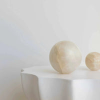 Large white onyx CoTheory Orbit Table Sculpture sphere symbolizing harmony and balance