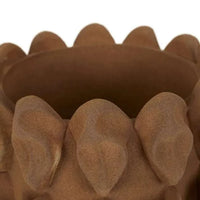 Close-up of brown textured sculptural vase rim with rounded petal-like design
