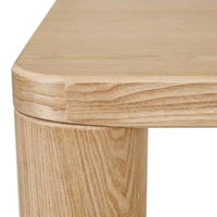 Close-up of GlobeWest Frankie Dining Table corner in natural ash veneer with rounded edge and chubby leg design