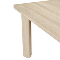 Corner detail of GlobeWest Montana Raft Dining Table in aged teak wood with slatted top and solid legs