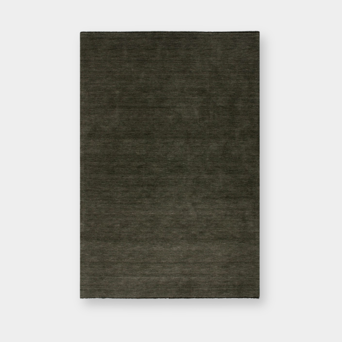 Sandringham Floor Rug in forest green with dense wool pile and subtle fringing, handknotted luxury design.