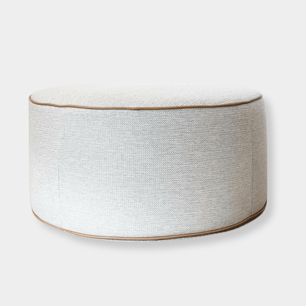norsu Ottoman in Lindeman Snow fabric with blush leather piping, round soft ottoman with foam coiled filling, available in various sizes