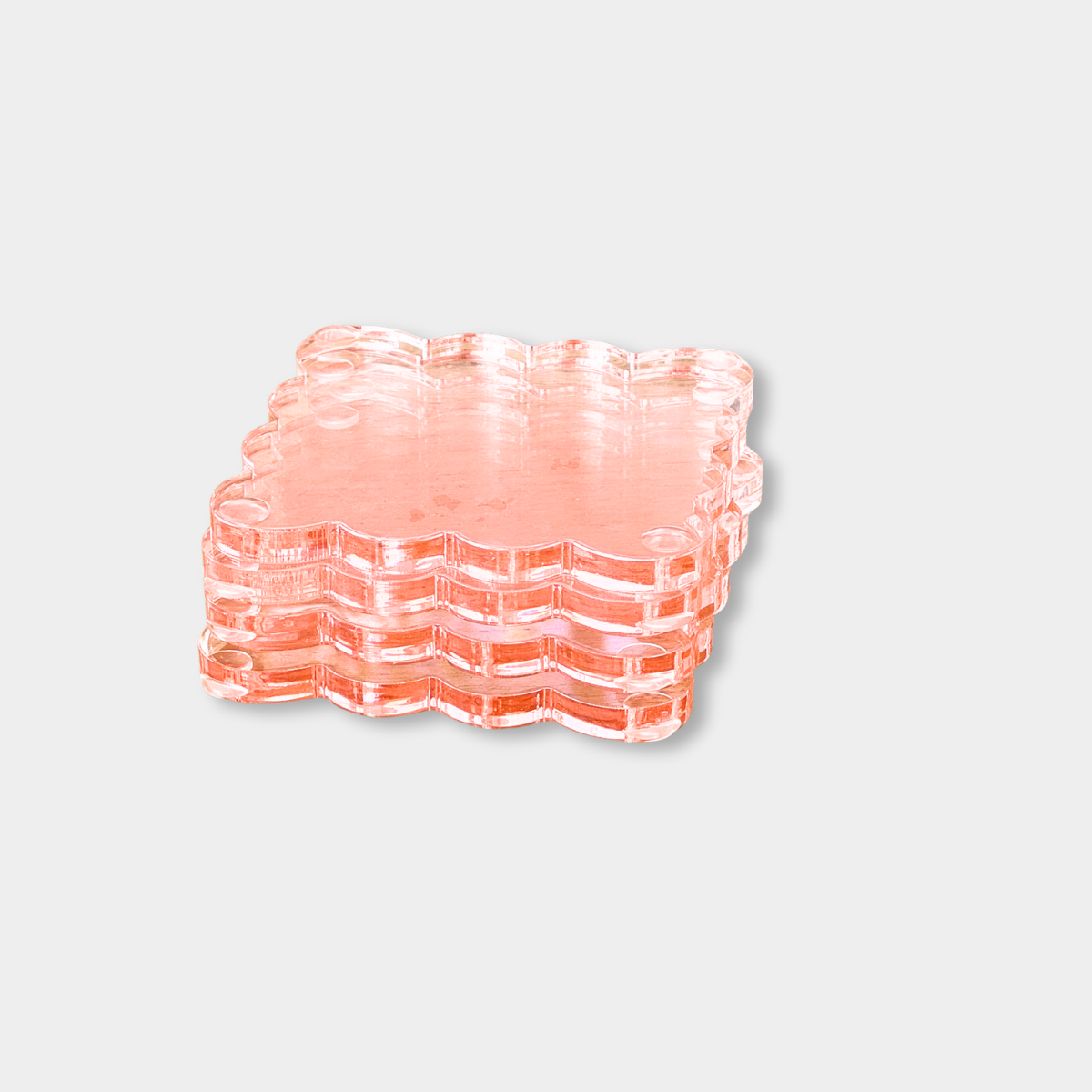 Set of 4 norsu Studio Perspex Scallop Coasters in translucent ochre with scalloped edges