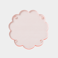 norsu Studio Perspex scallop tray in translucent pink-toned ochre with scalloped edges, lightweight and durable trivet tray