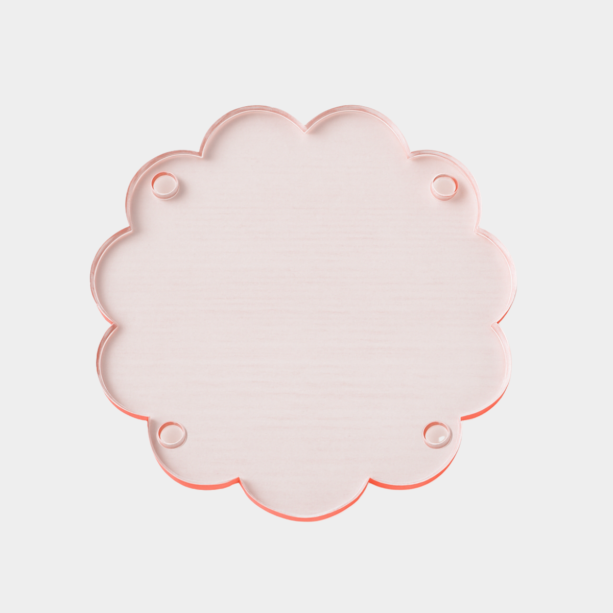 norsu Studio Perspex scallop tray in translucent pink-toned ochre with scalloped edges, lightweight and durable trivet tray