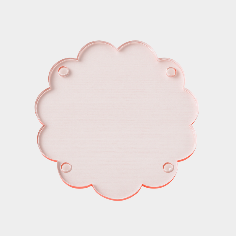 norsu Studio Perspex scallop tray in translucent pink-toned ochre with scalloped edges, lightweight and durable trivet tray