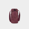 Base Supply Bottle Sling crossbody in burgundy, waterproof, adjustable strap, with front zipped pocket and drawstring top closure.
