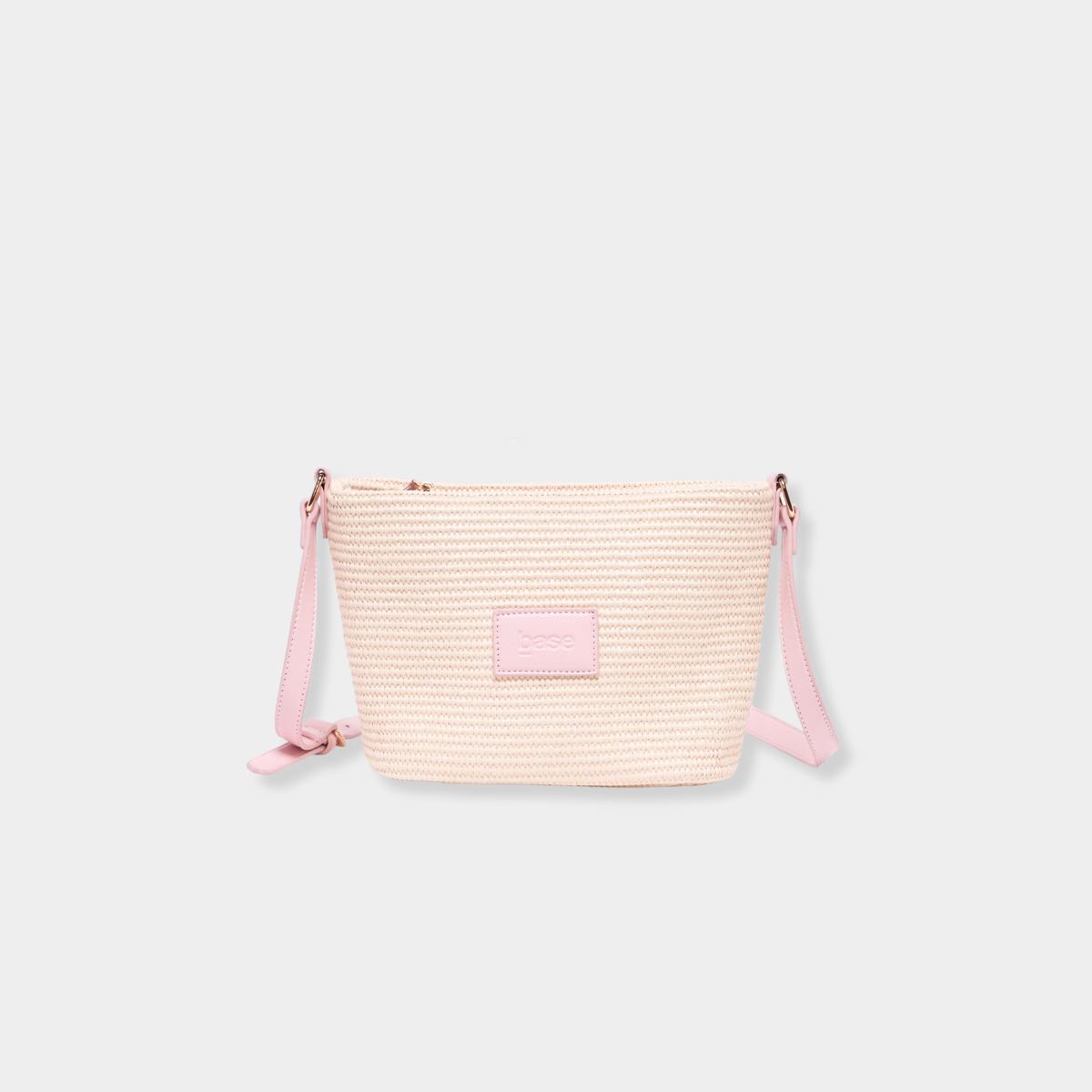 Pink woven Base Supply Panier Crossbody bag with adjustable strap and zip-top closure