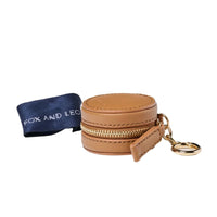 Tan Fox and Leo Eye Catcher bag charm with leather zipper case and gold ring clip, includes microfibre cleaning cloth.