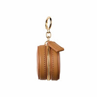 Fox and Leo Eye Catcher Bag Charm in tan leather with gold hardware and zipper closure, featuring a circular ring clip and microfiber cleaning cloth.