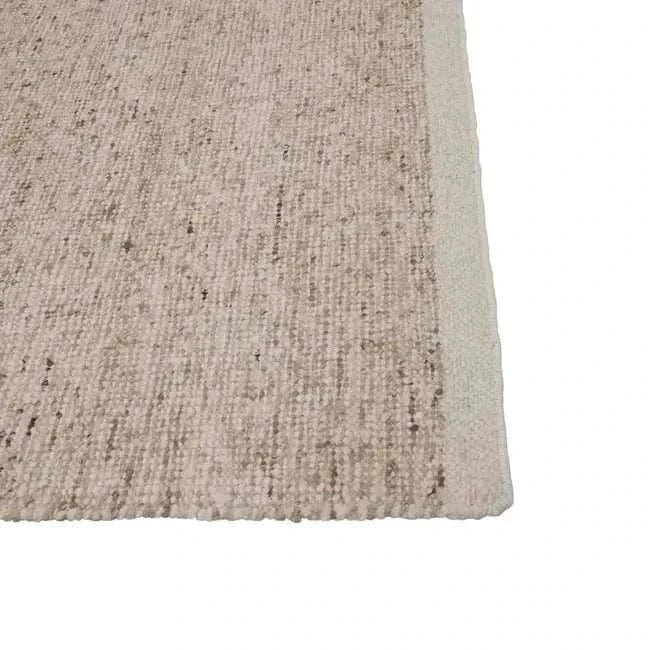Stone color GlobeWest Tepih Maren Rug handwoven wool textured close-up corner view