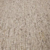 Close-up of GlobeWest Tepih Maren hand-woven wool rug in stone color showing texture and subtle color variations