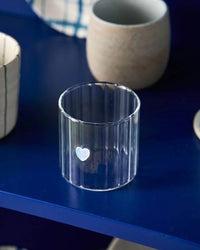 Robert Gordon Haven Glass Tumbler with heart motif on dark blue surface, lightweight borosilicate glass, 325ml capacity
