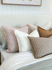 Ivory norsu Cabin Bedhead king size with textured fabric and self-piped trim behind bed with assorted neutral pillows