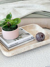 CoTheory Orbit Table Sculpture Rosso Levanto marble sphere on beige tray with books and potted plant