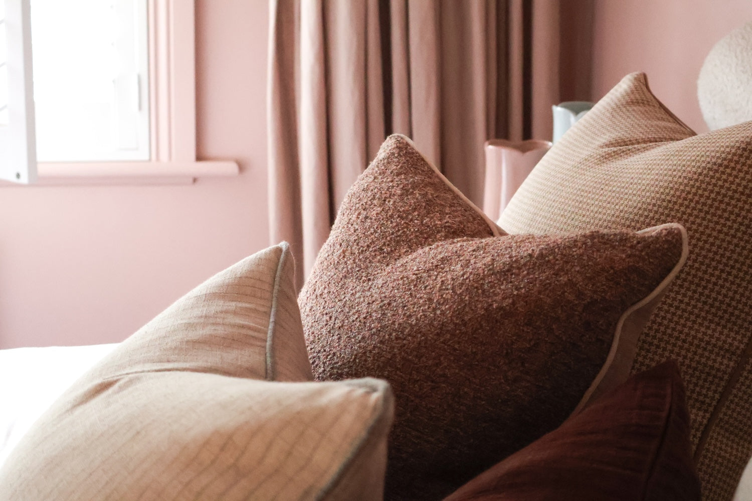 norsu Studio Forma Collection Elysian reversible blush cushion with luxe fringing and feather-down fill