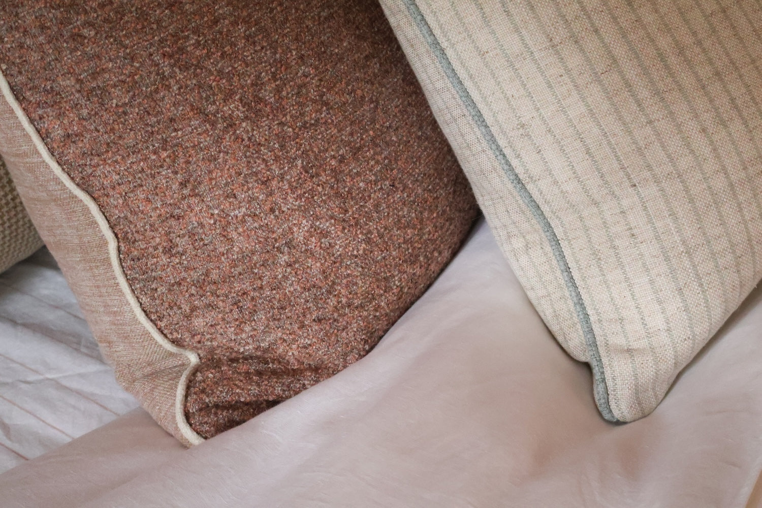 Reversible blush Elysian Cushion from norsu Studio Forma Collection with luxe fringing and feather-down filling