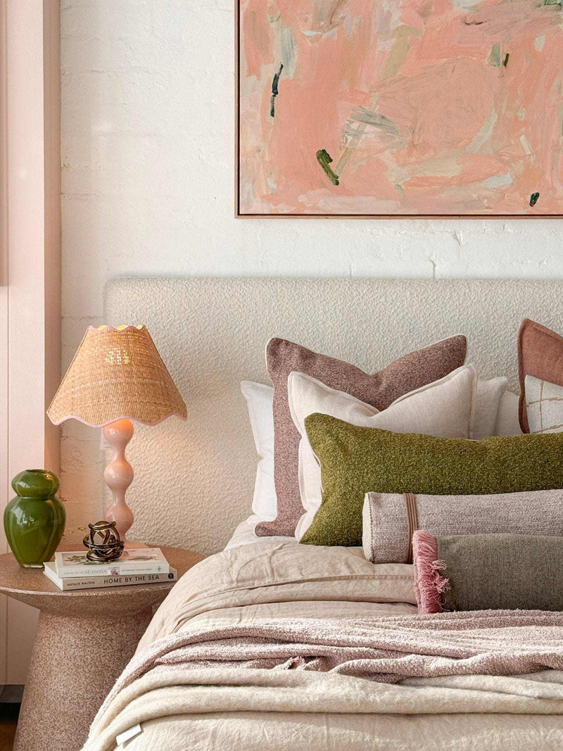 Oak framed Vanni Limited Edition fine art canvas print "Under a Safe Sky" 100x100cm displayed in a cozy bedroom setting with neutral bedding and a side table lamp.