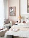 Oak framed Marcia Priestley 'Chaps Rosata' signed canvas print hanging in a soft neutral bedroom interior