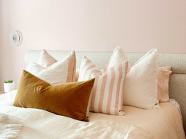 Eadie Lifestyle Luca Boho white linen cushions with hand-frayed edges in various sizes on a bed