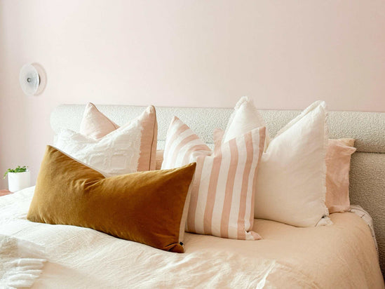Eadie Lifestyle Luca Boho white linen cushions with hand-frayed edges in various sizes on a bed