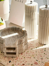 Lorne Salt + Pepper Mill in natural marble with sleek, fluted design on kitchen countertop