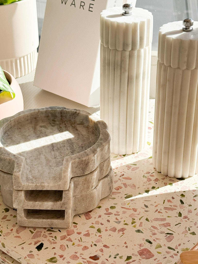 Lorne Salt + Pepper Mill in natural marble with sleek, fluted design on kitchen countertop