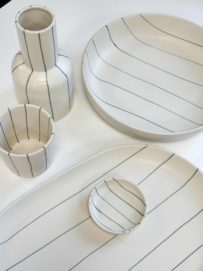 Robert Gordon Coastal Junction cream stoneware set with green stripes, including carafe, cups, and plates.