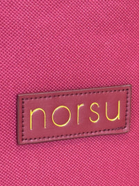Close-up of woven fabric texture with gold norsu branding on norsu Studio Christmas Ornament storage box