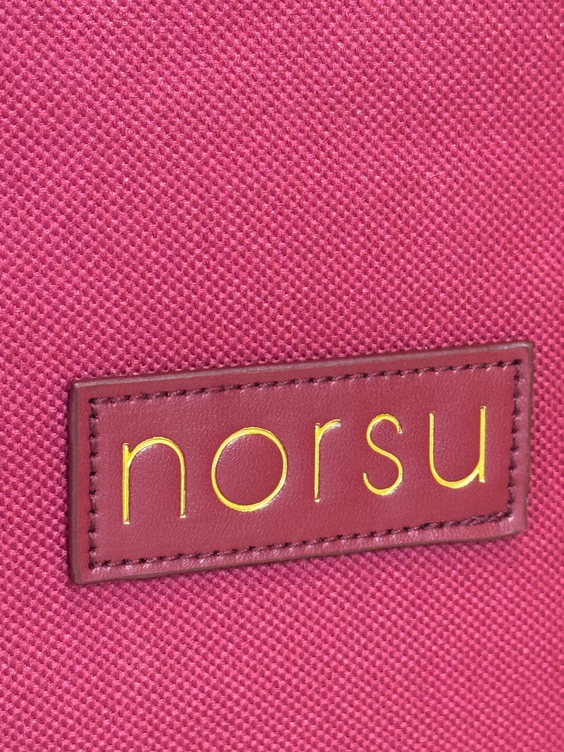 Close-up of woven fabric texture with gold norsu branding on norsu Studio Christmas Ornament storage box