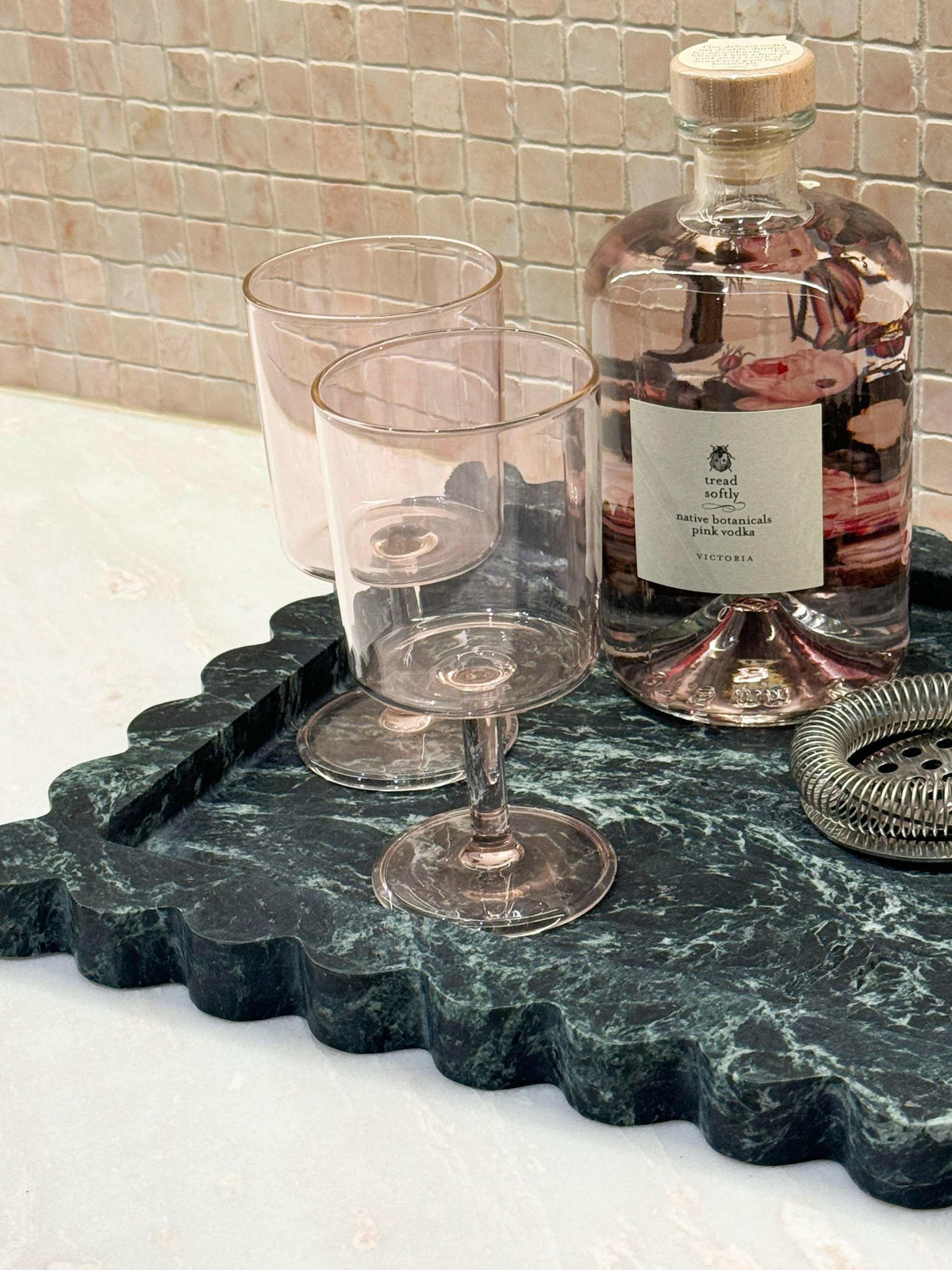 CoTheory Marble Tray large scalloped Verdi Alpi green marble bar tray with glassware and bottle on countertop