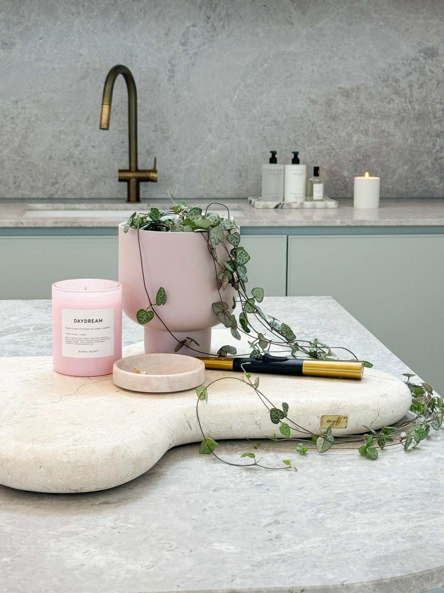 Bondi Scent Candle Daydream in pink glass with greenery on marble countertop for home decor and relaxation