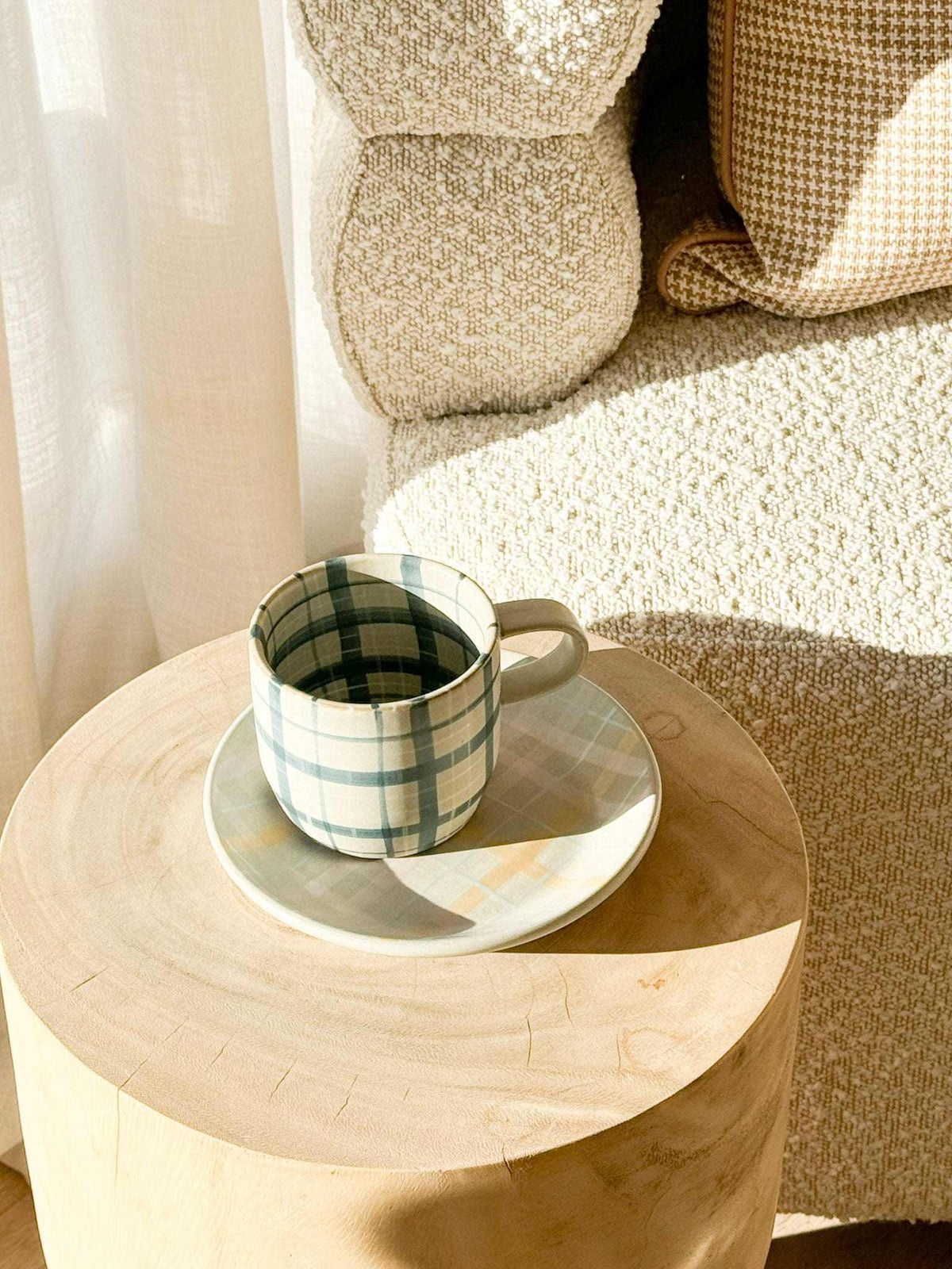 Robert Gordon Hand-Painted Mug with blue and white tartan design on wooden table in cozy living room setting