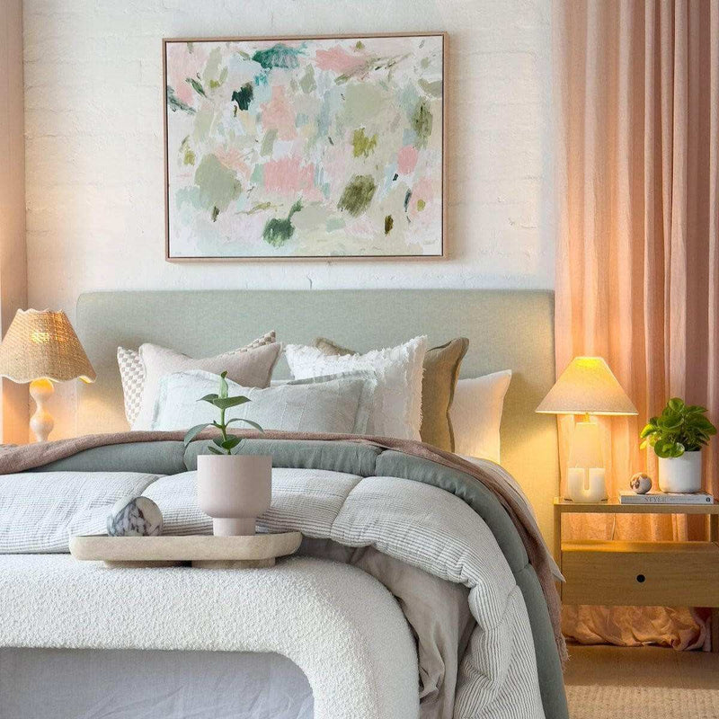Oak framed Vanni Blushing Meadows limited edition abstract art canvas print above bed in cozy bedroom setting