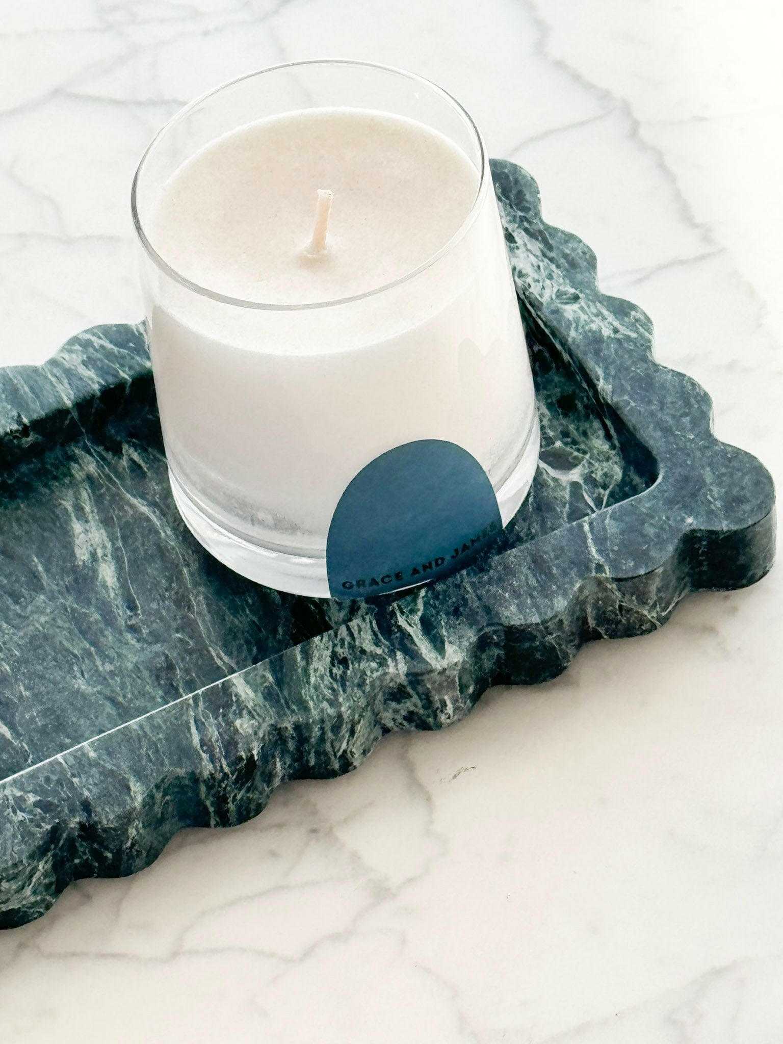 CoTheory Palazzo scalloped marble bar tray in Verdi Alpi with candle