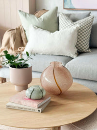 GlobeWest Boden Stripe Wide Vase in blush handblown glass with delicate stripes on wooden coffee table in living room