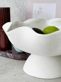 Ripple White Pedestal Bowl with glossy interior and textured ceramic exterior displaying fruits