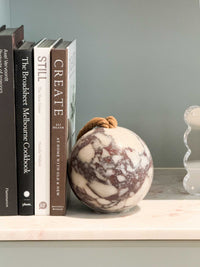 norsu Studio Viola Marble Door Stop with purple and cream veining and adjustable cotton strap